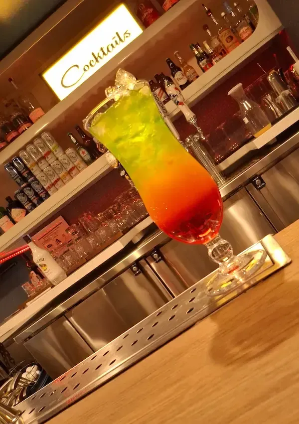 Colorful layered tropical cocktail served at an Avilez Mobile Bar event in Las Vegas