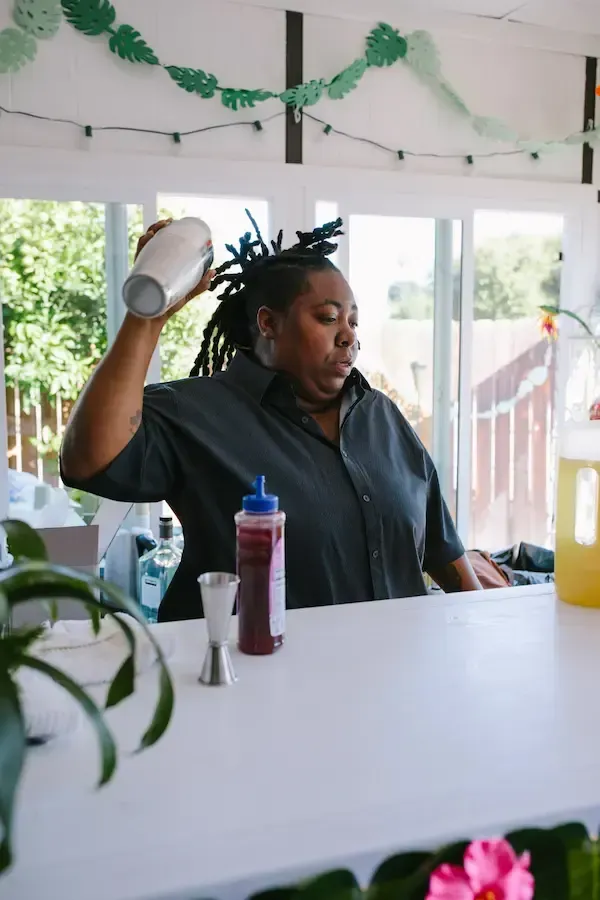 Lesley Gillett - Belizean master bartender crafting an elite cocktail