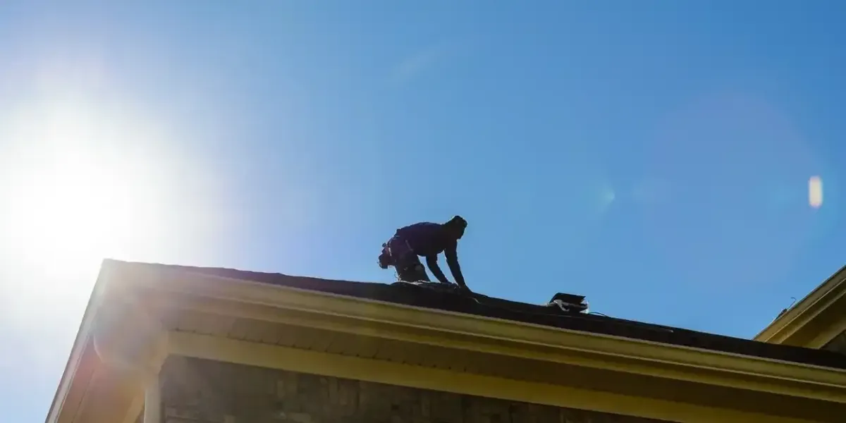 rofing expert installs new roof tiles on the top of resi