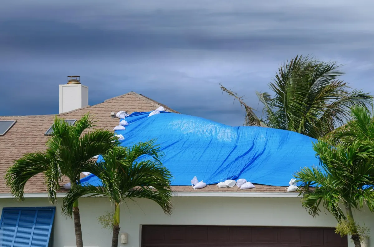 C&H Exteriors, Roofing Contractor - emergency tarp cover on rooftop after storm damage