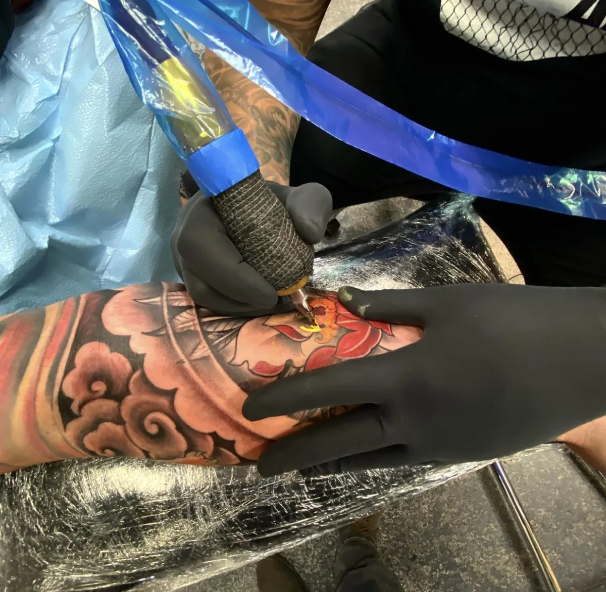 a lit up sign that says tattoo on it