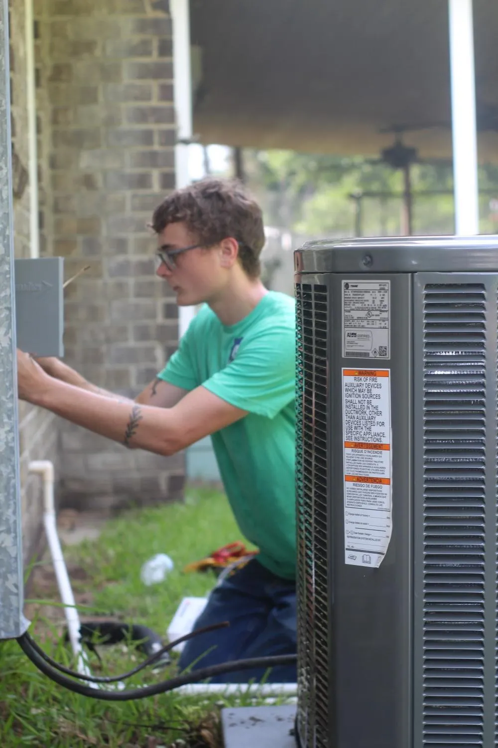 HVAC technician repairing outdoor AC unit at a home in Summerville SC - Goat Heating & Cooling