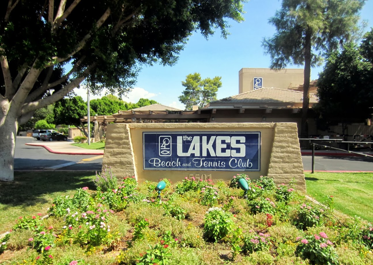 A calendar page with a highlighted yoga class booking, surrounded by a water bottle, yoga mat, and a smartphone displaying a confirmation. The setting is a tidy desk with natural light, suggesting easy online booking and organization.