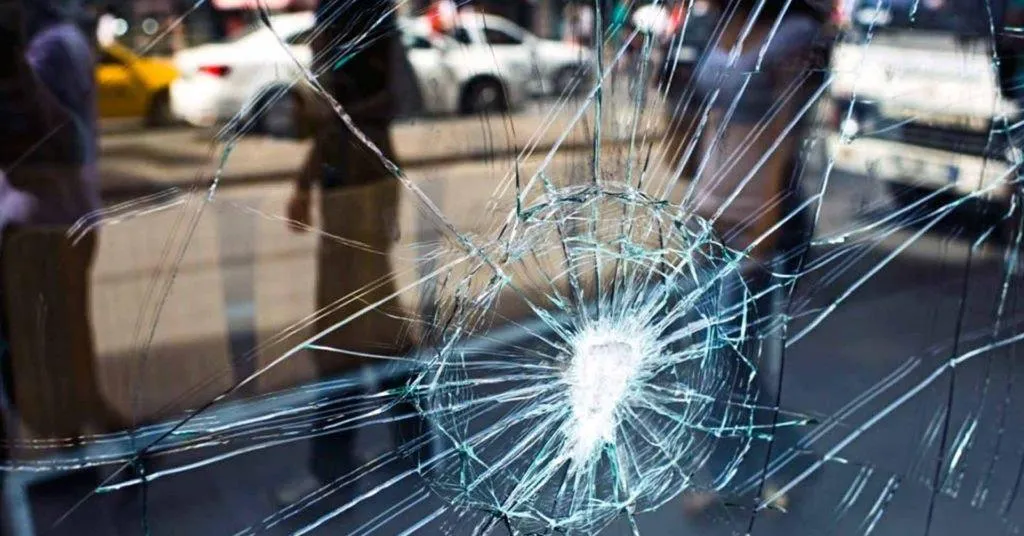 a kitchen with a sink and a lot of clutter on the counter