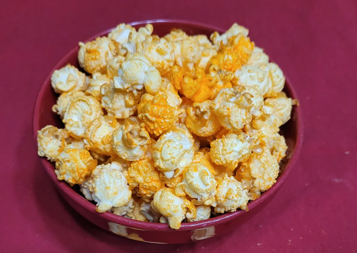 cheddar kettle corn popcorn presented in a red bowl