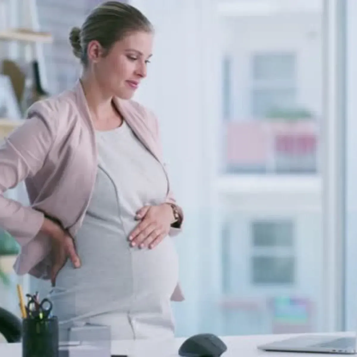 Pregnant woman holding belly