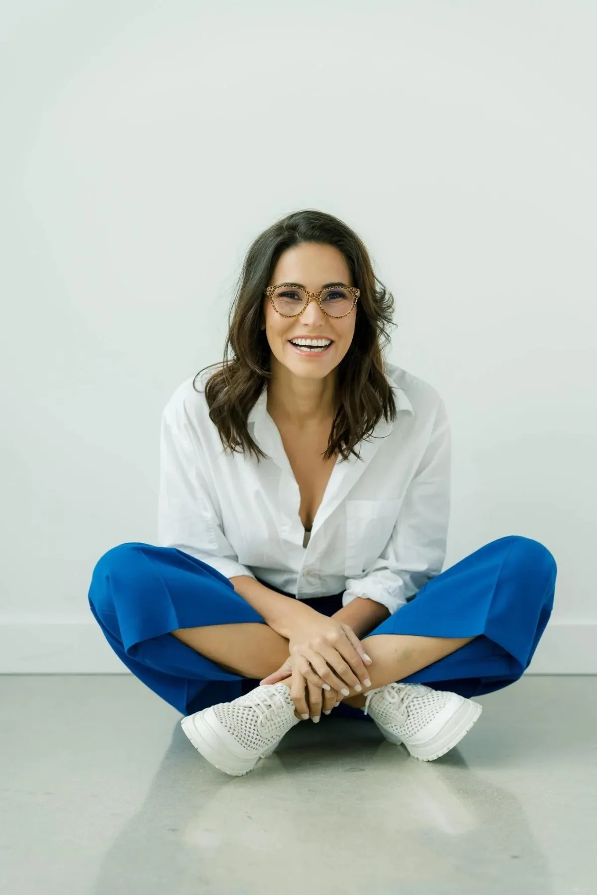 Eva McCage smiling and seated casually, representing coaching for career, parenting, and emotional well-being