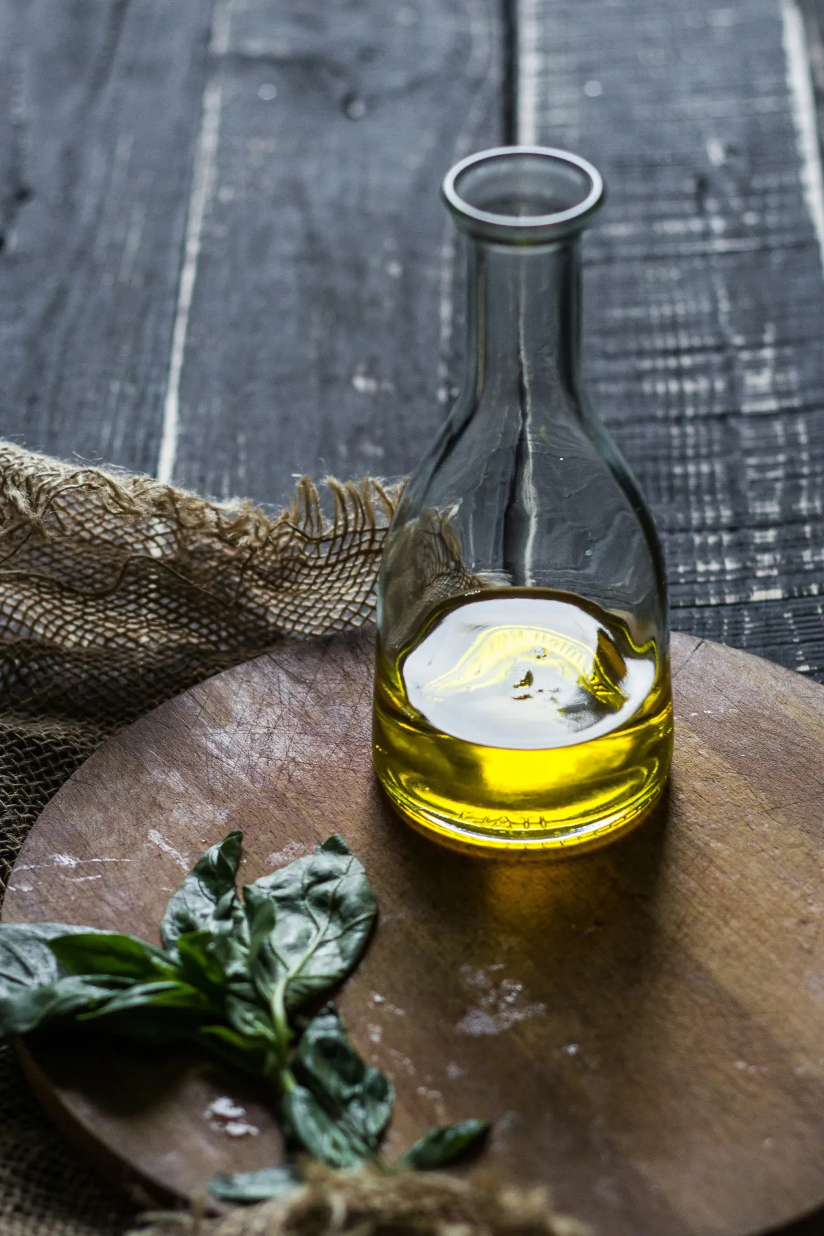 Olive oil and basil representing nourishing healthy fats and hormone balance for women’s metabolic reset.