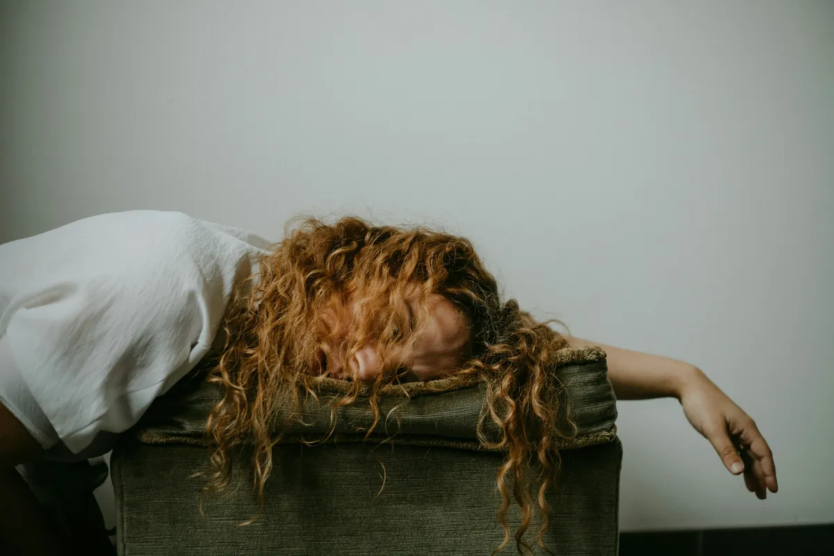 Woman exhausted sleeping on her side