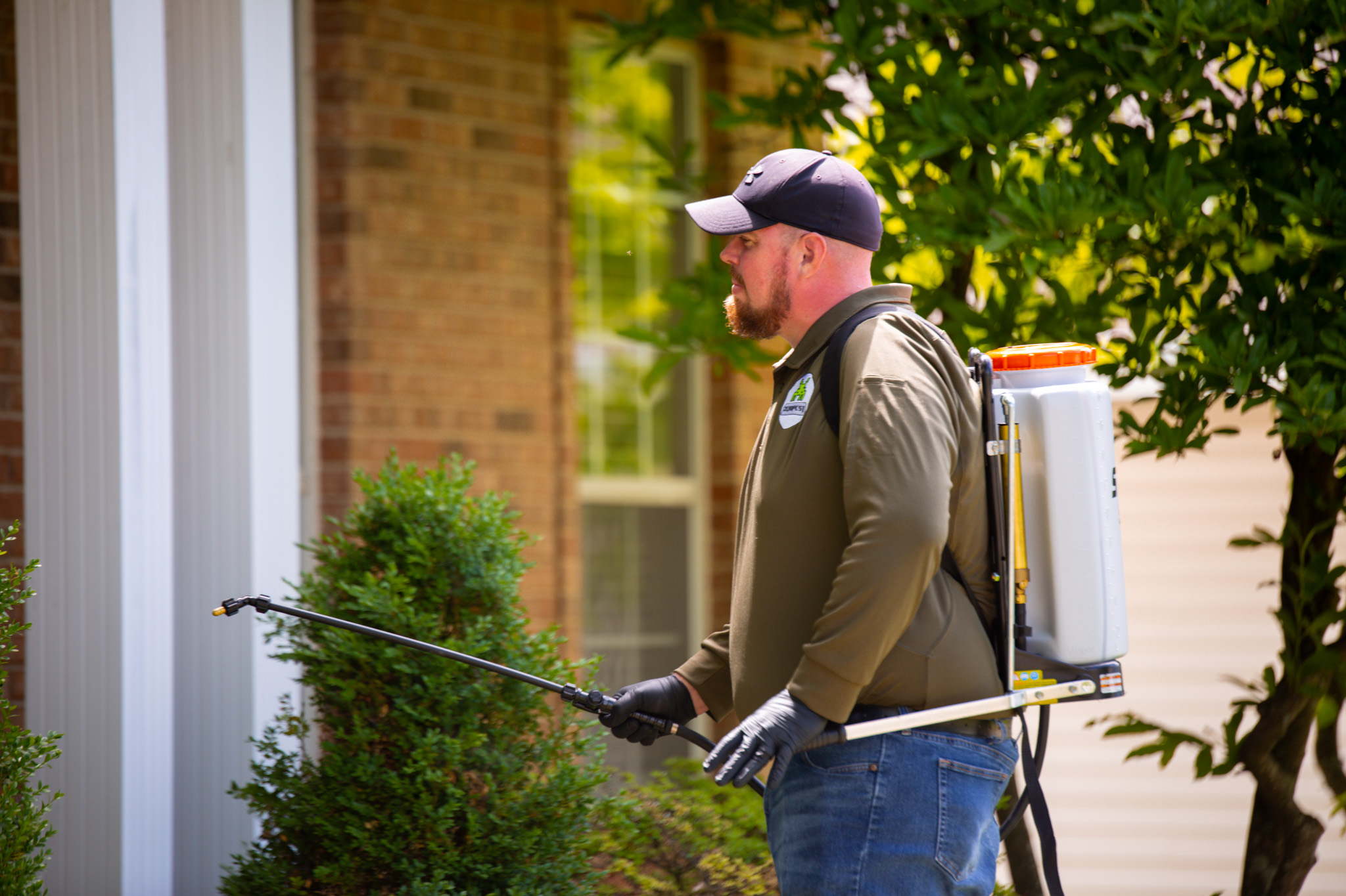 Zero Pest technician treating around a St. Louis home for brown recluse spiders