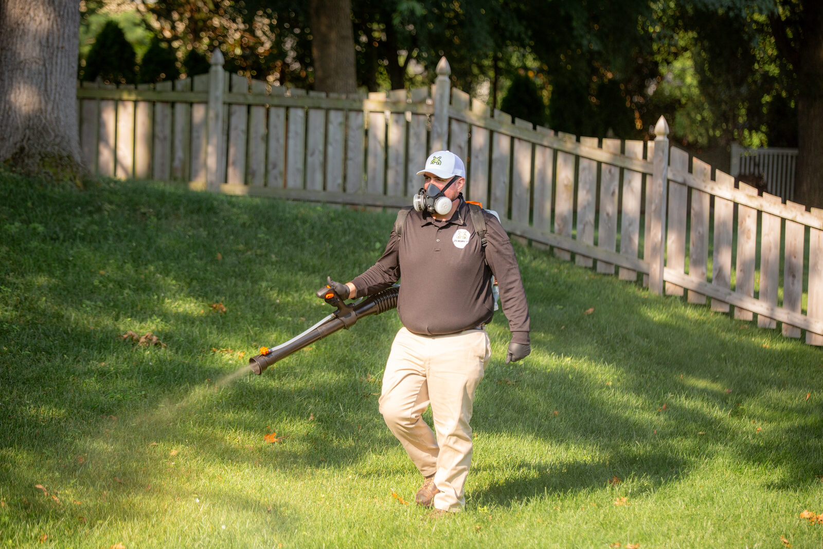 Zero Pest technician treating a St. Louis backyard for mosquitoes and ticks