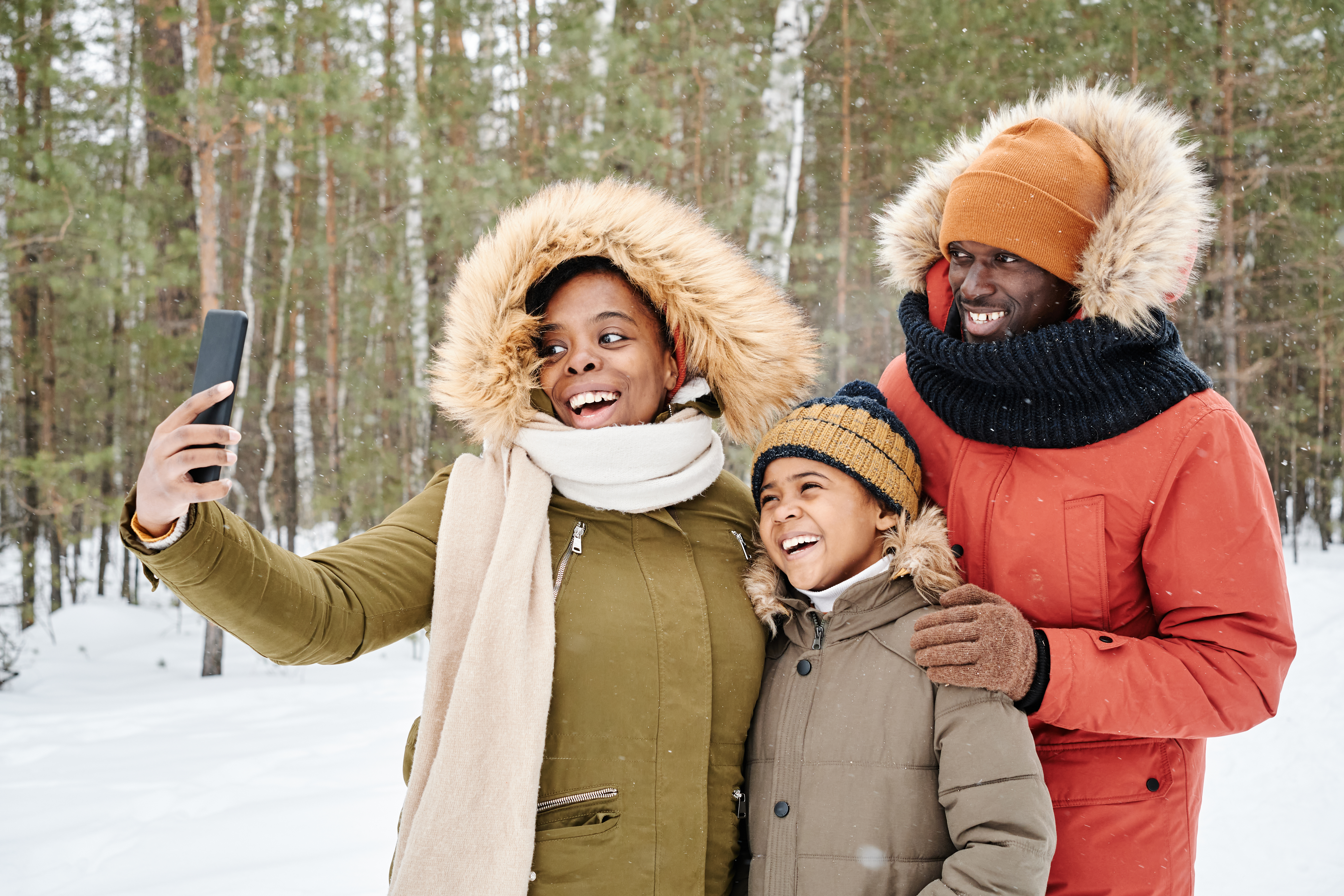 Young family laughing together in a park in Ottawa