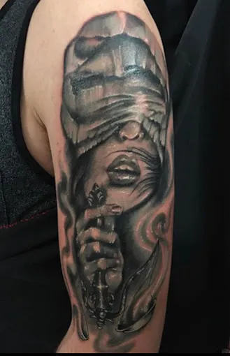 Close-up of a black and grey lion face tattoo