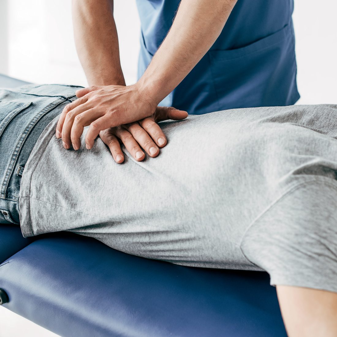 A chiropractor adjusting a patient's back
