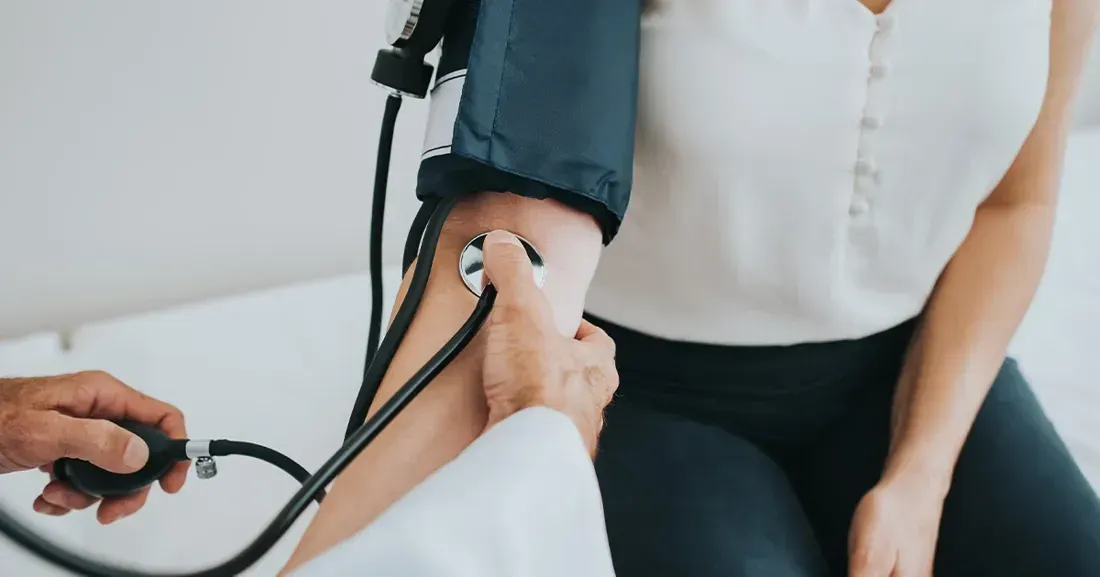 A doctor taking a patient's blood pressure