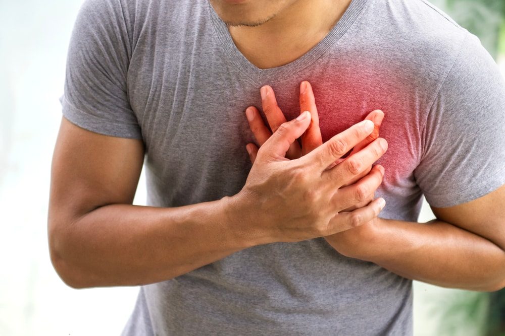 A person clutching their chest in pain