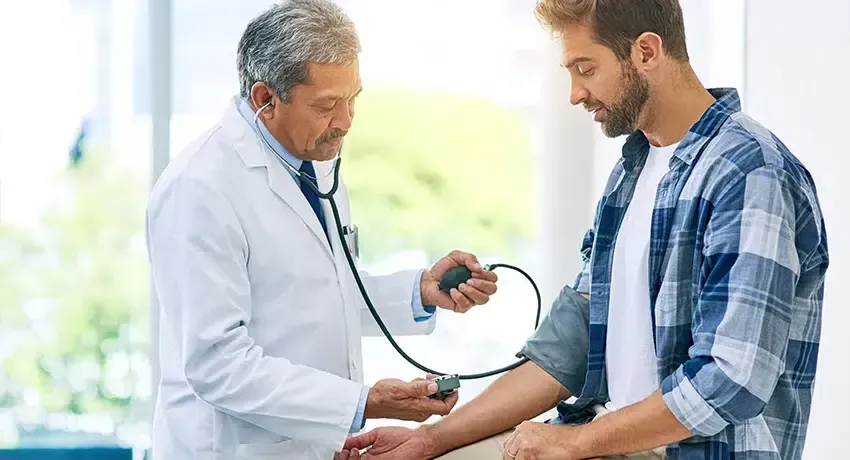 A doctor taking a patient's blood pressure