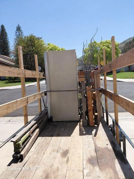 Commercial junk removal by Rabbits Services, featuring a refrigerator being hauled from a business property in Lake Elsinore, Corona, and Riverside