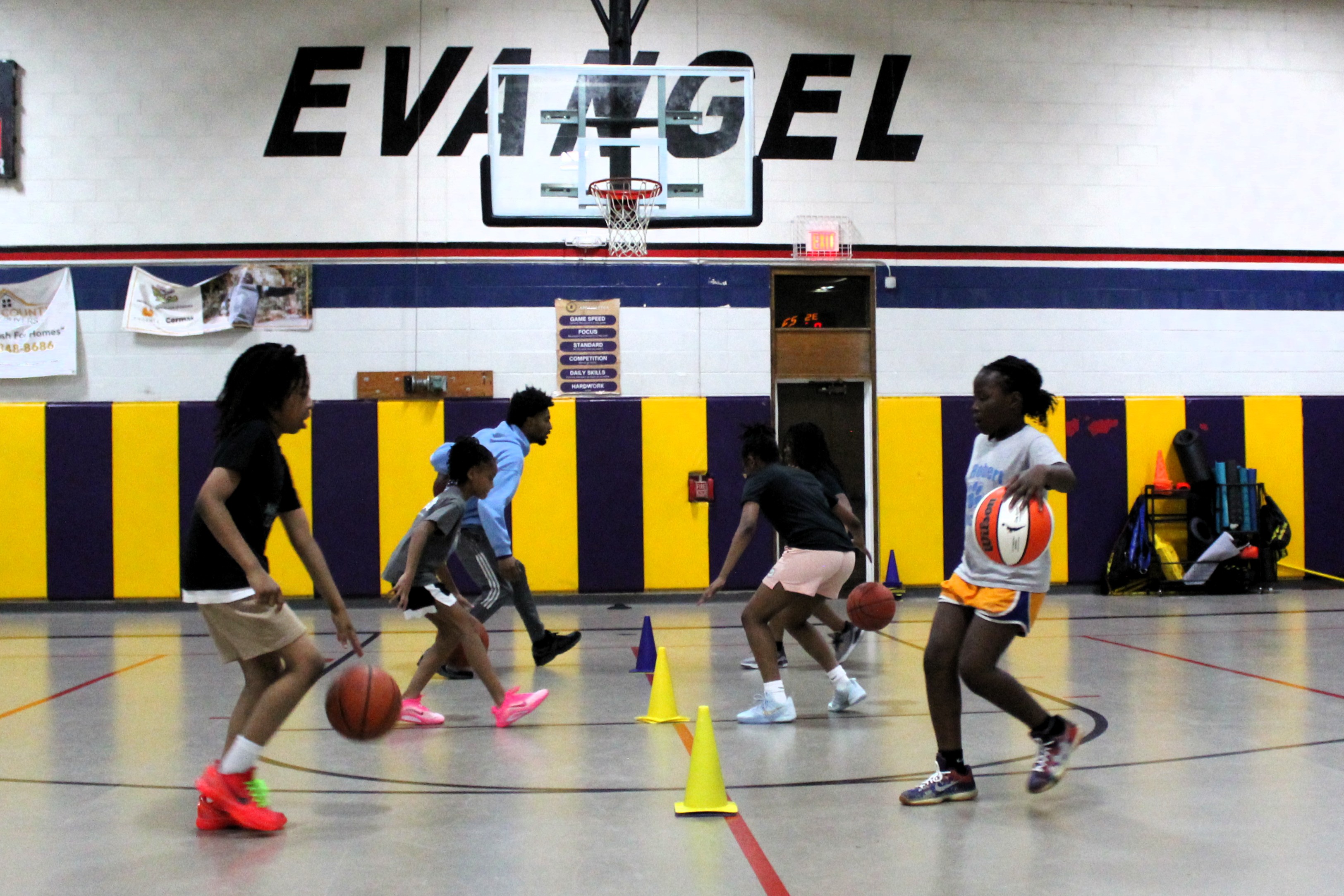a group of young men playing a game of basketball