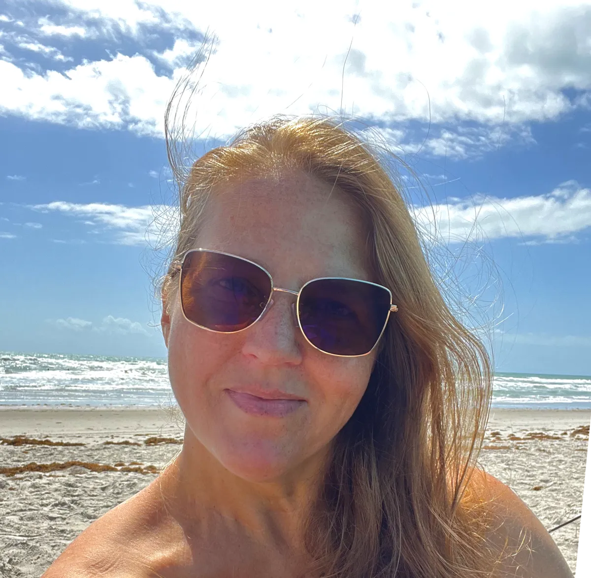Meredith L. McGuire McConn in front of an ocean in Florida