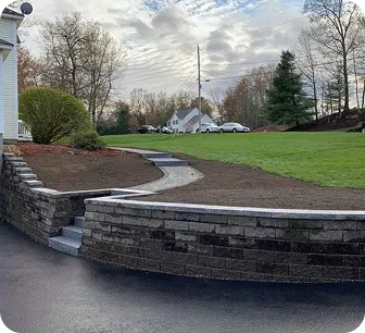 Curved retaining wall bordering a residential yard
