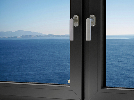 Close-up of a dark grey window frame featuring a small smart sensor or lock mechanism with a glowing red LED indicator.
