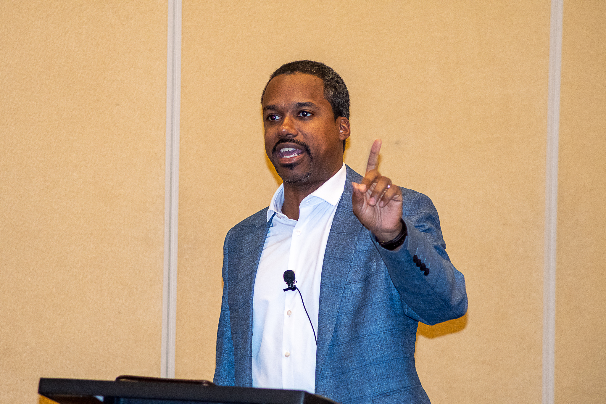 a man sitting on the ground in front of a building