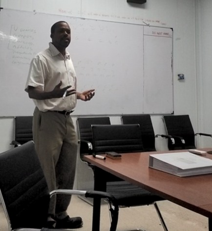 grayscale photo of 3 women sitting on wooden bench