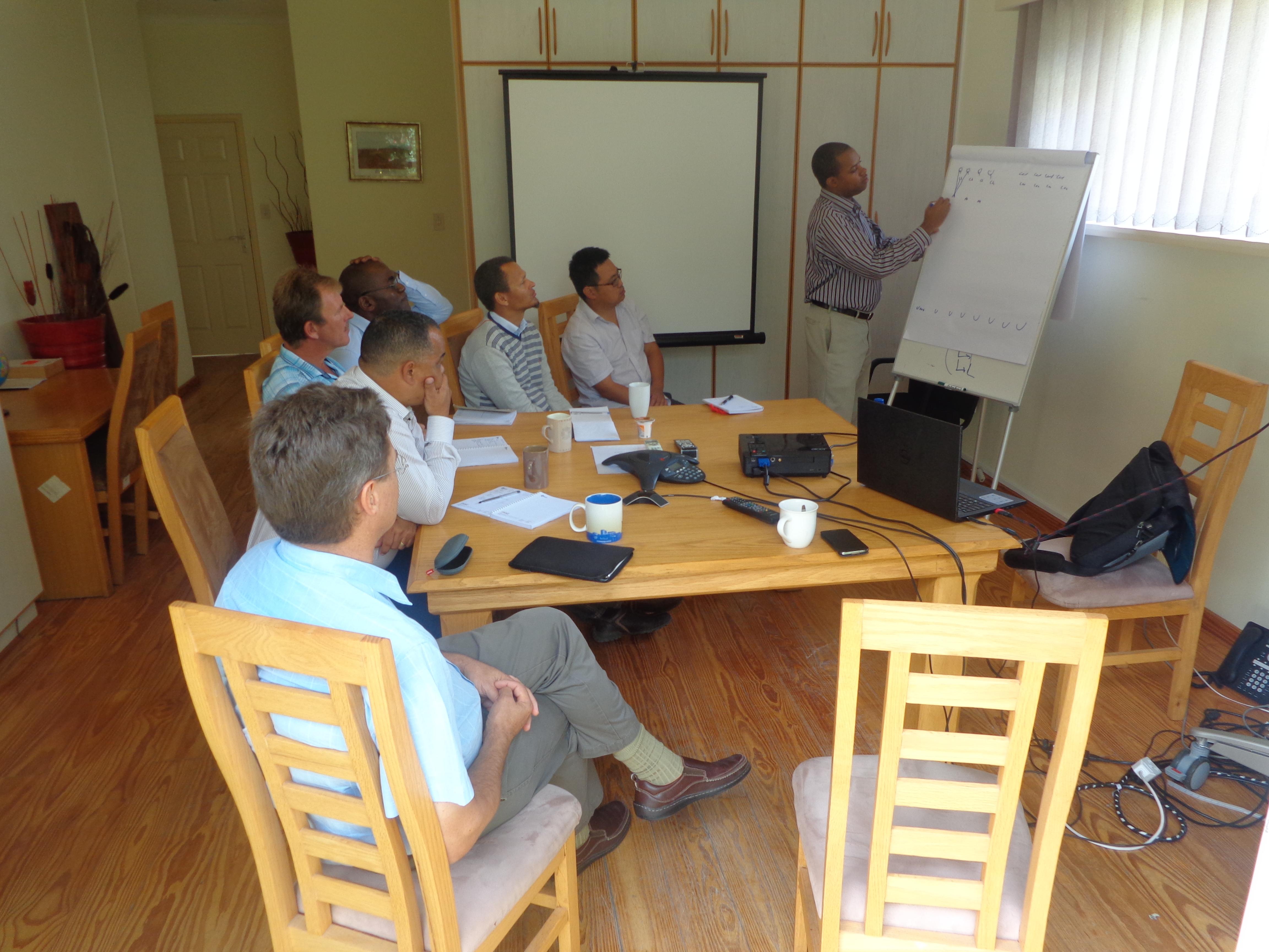 grayscale photo of 3 women sitting on wooden bench
