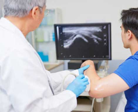 Large institutional buildings surrounded by green lawns and trees.