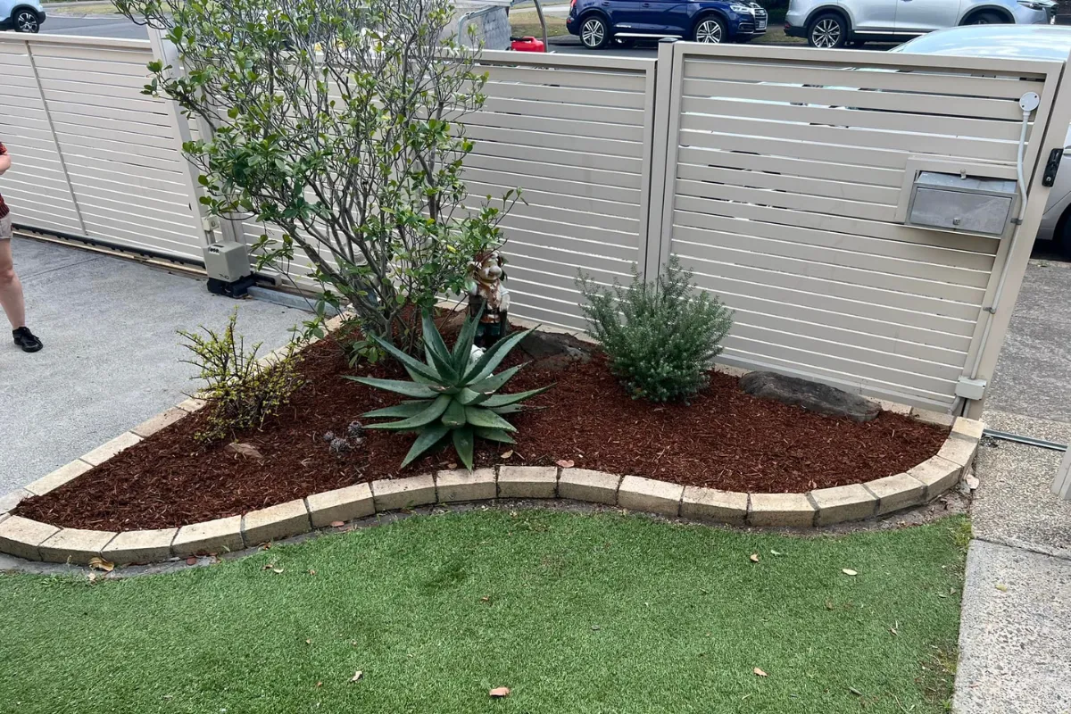 Professional garden bed mulching and hedge maintenance featuring fresh organic mulch for a healthy residential garden in the Eastern Suburbs