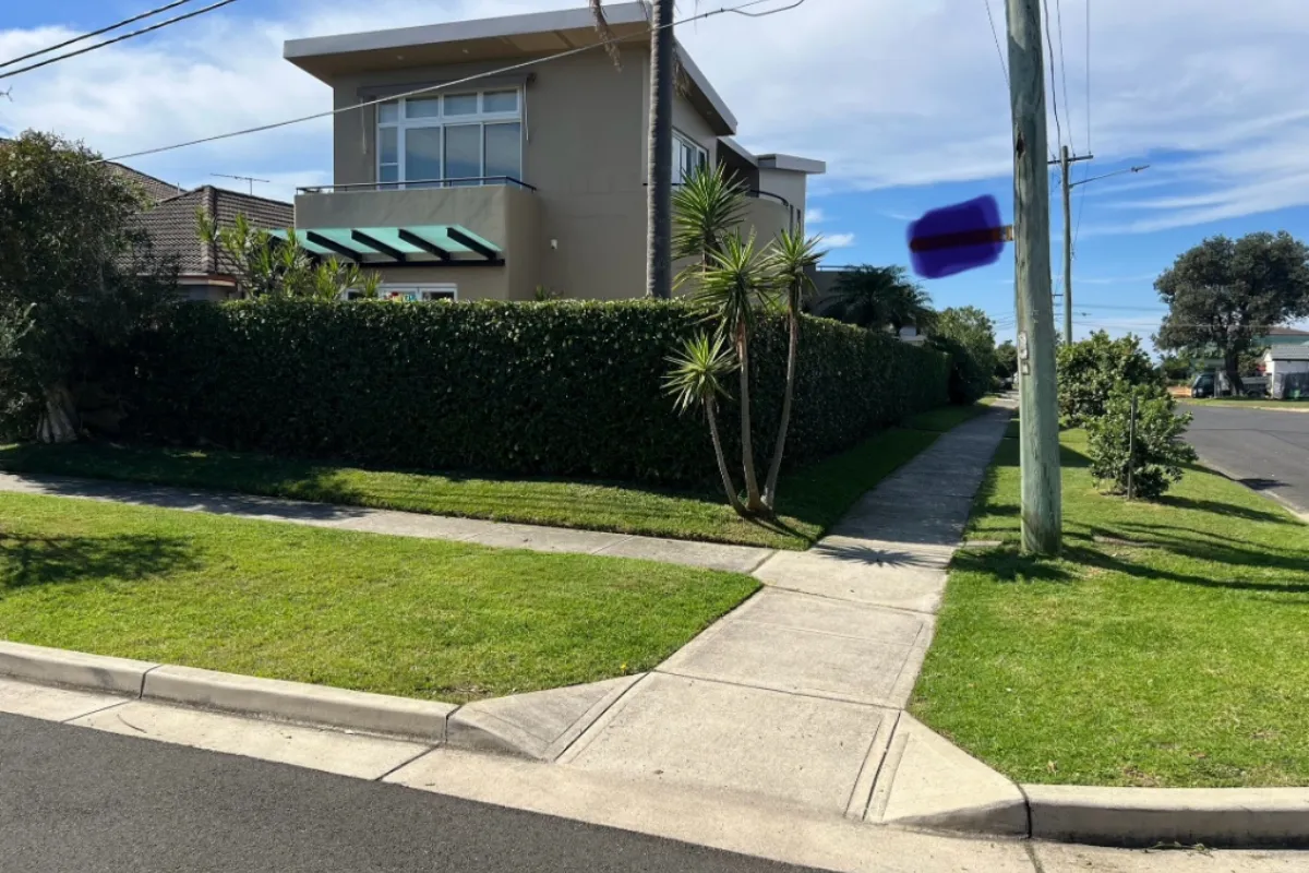 Freshly mown and edged residential lawn showing professional striping and clean garden borders.