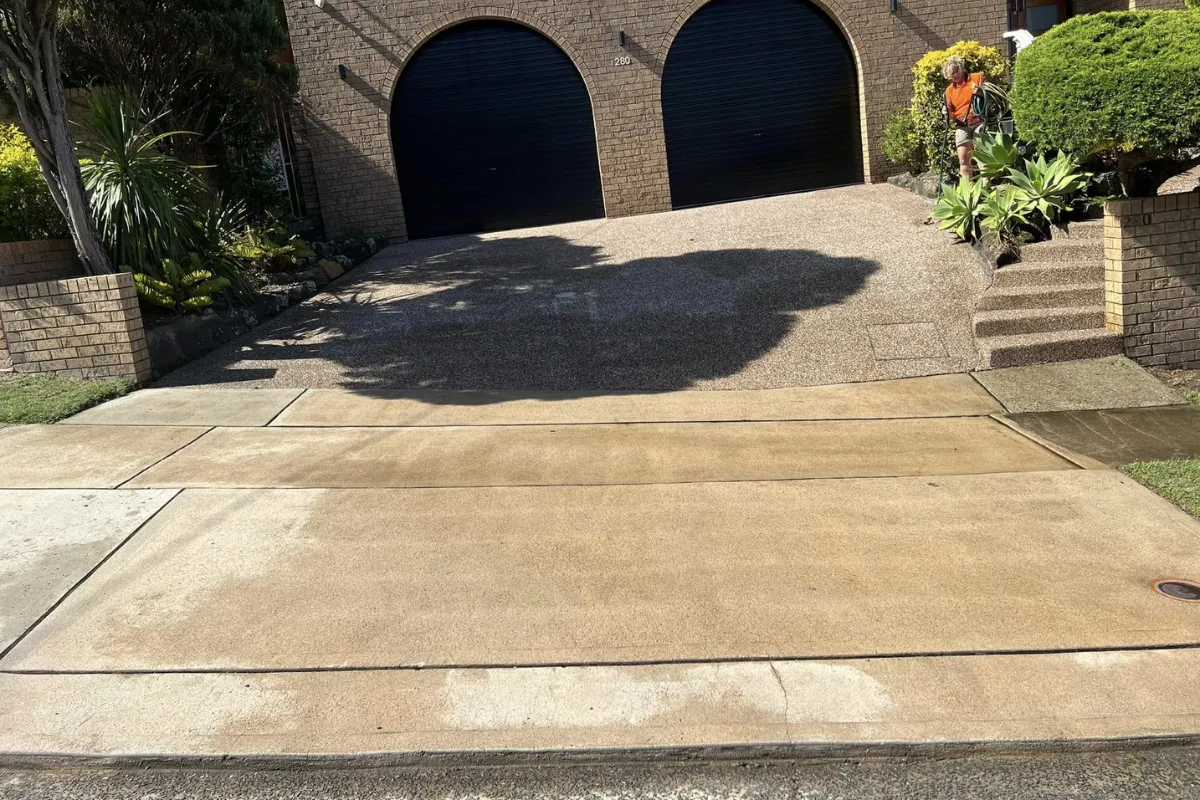 Large clean concrete driveway after professional high-pressure washing