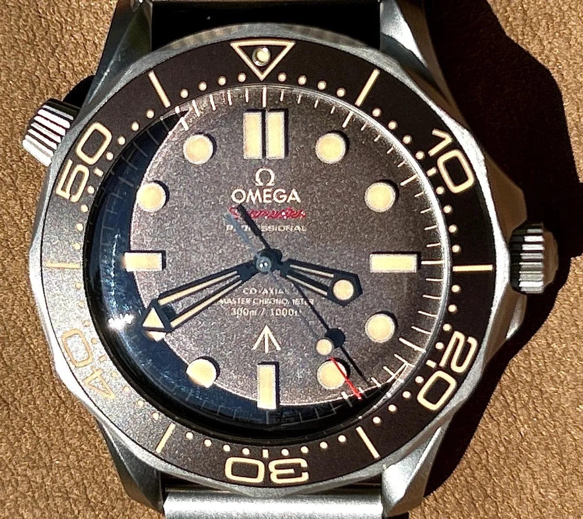 round silver-colored Fossil chronograph watch at 9:22 with brown leather band