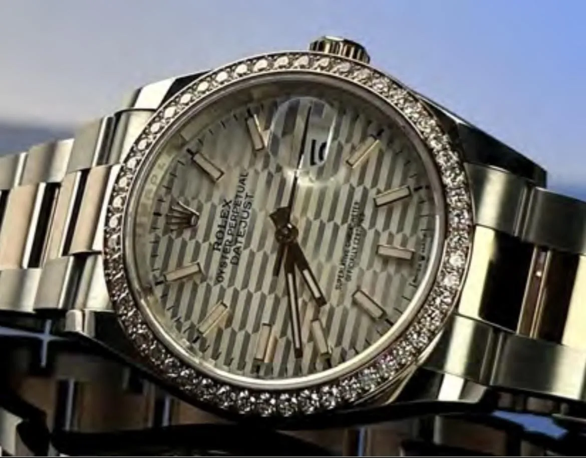 three round silver-colored chronograph watches on white mounts