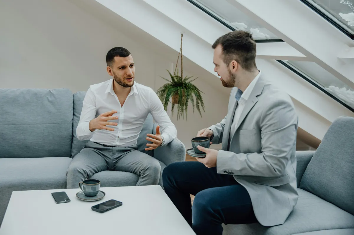 three person pointing the silver laptop computer