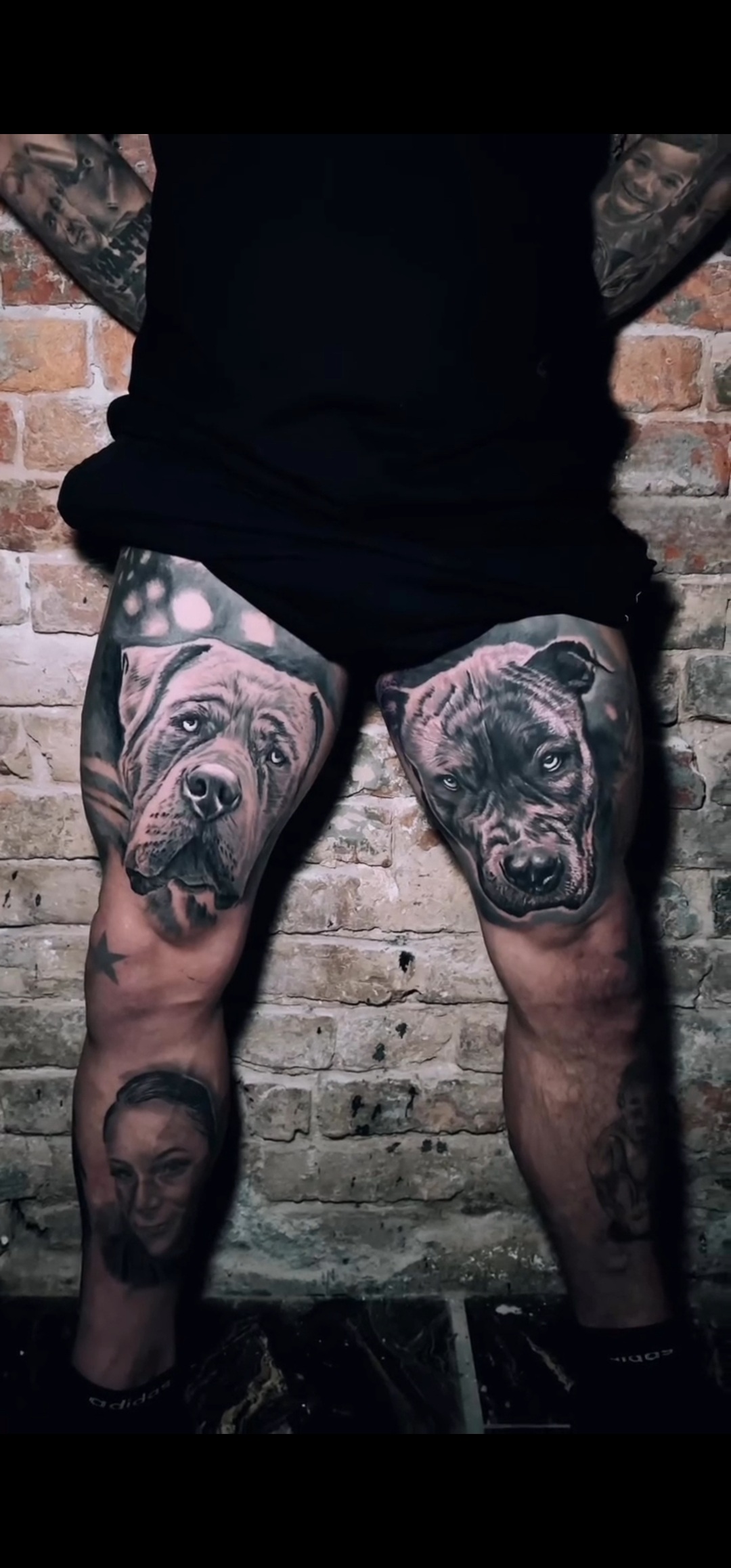 person in blue denim shorts and white nike sneakers standing on gray concrete floor