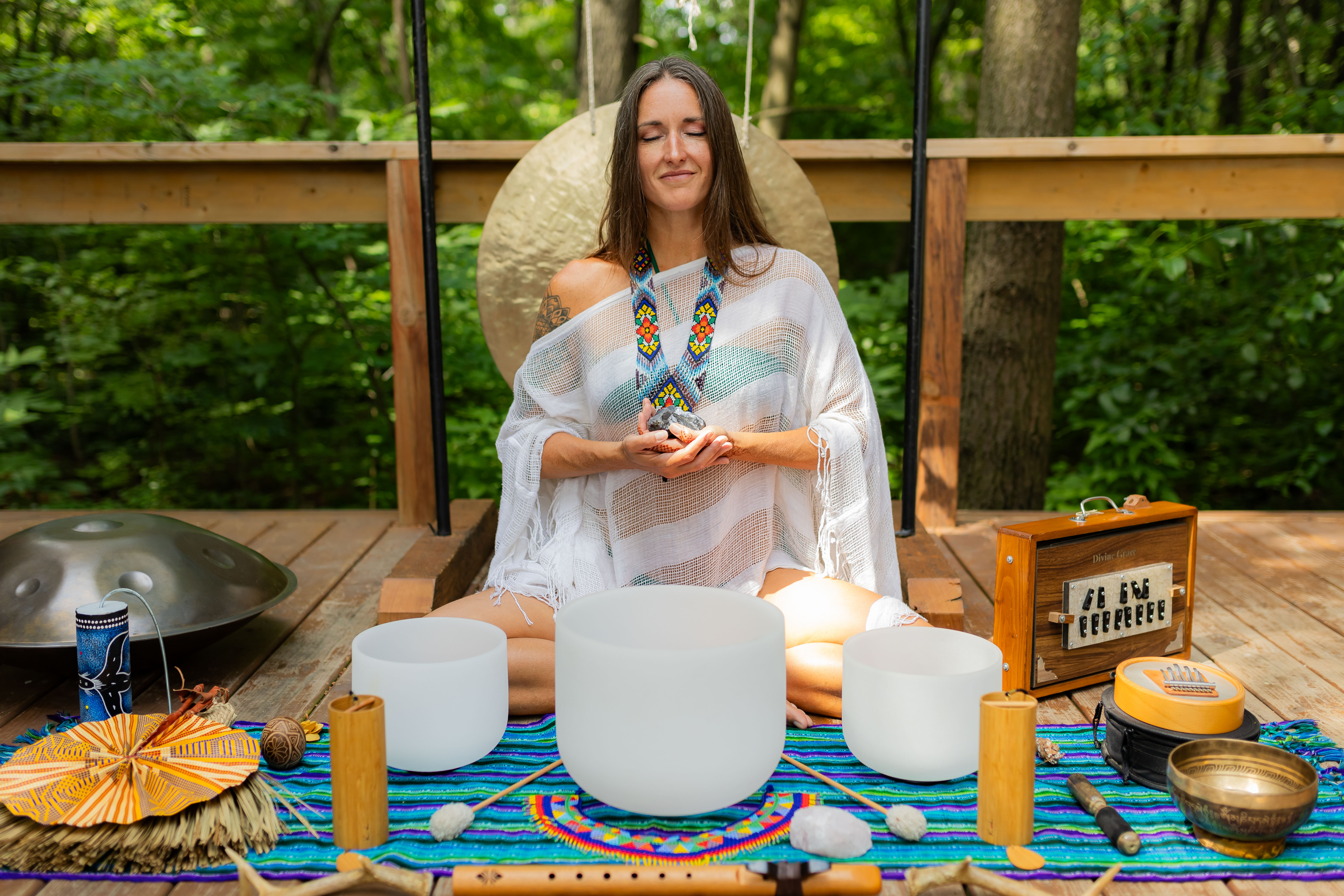 Hands offering a small crystal bowl on linen
