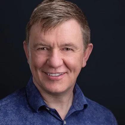 A person placing a piece of wood into a pyramid