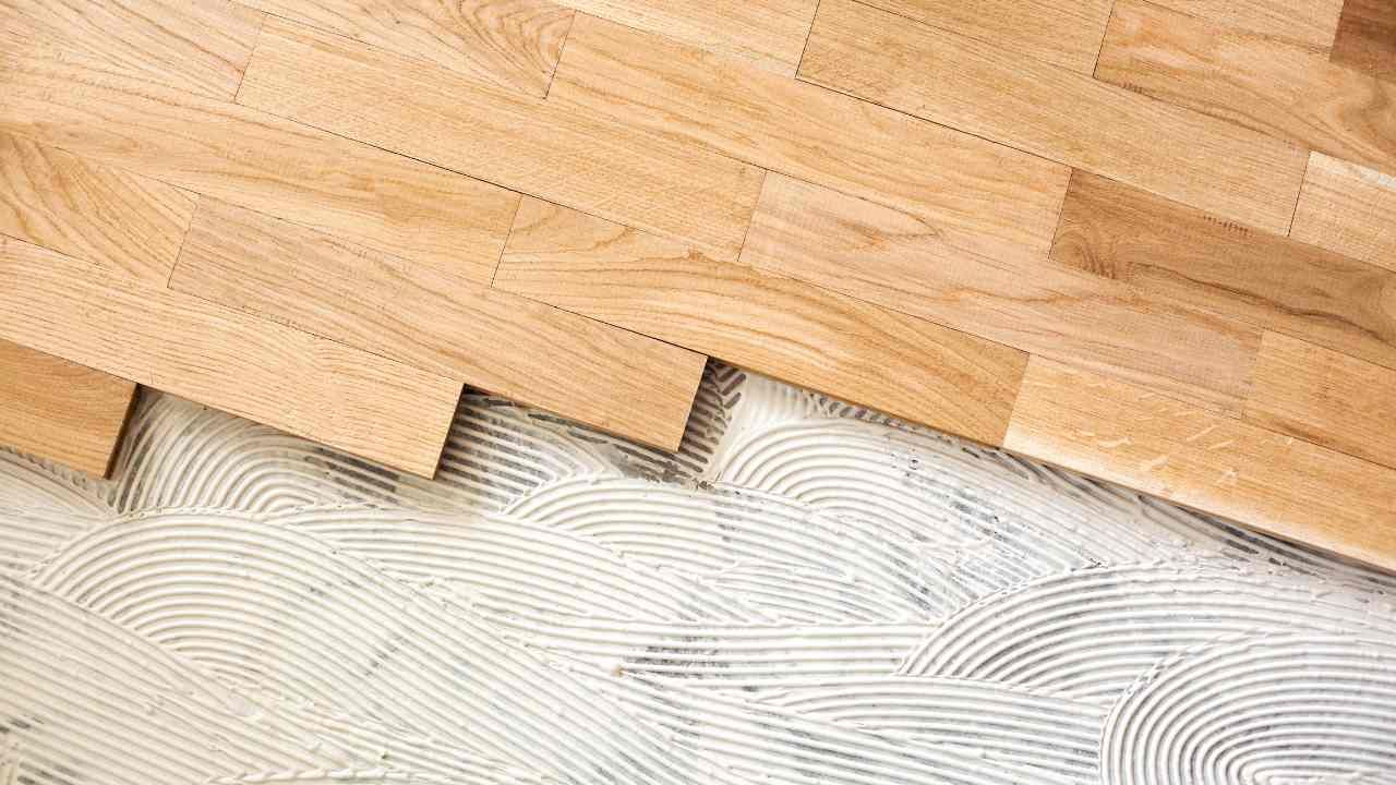 A close up of a wooden floor being installed.