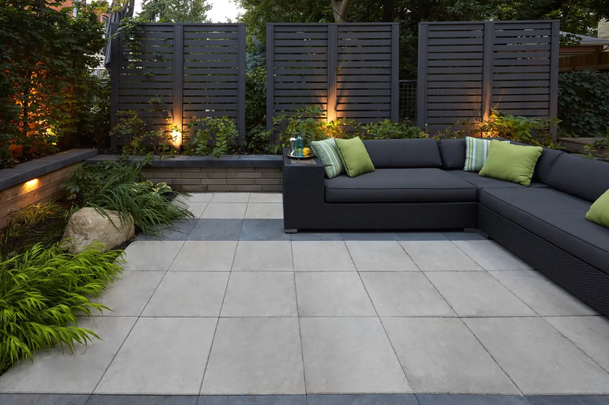 a patio with a black sofa