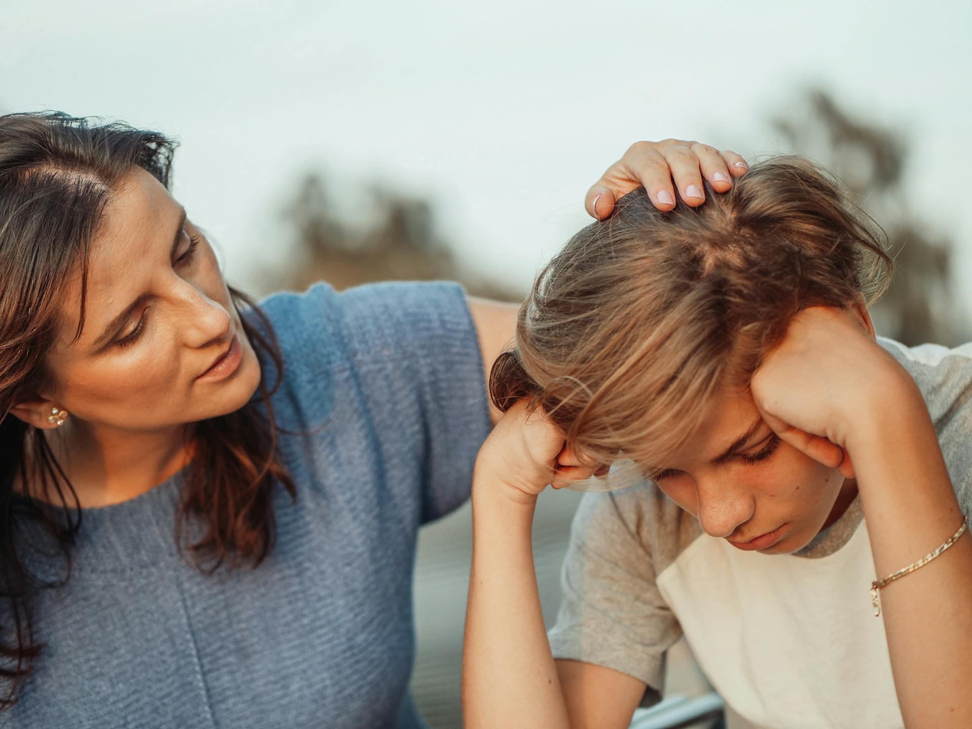 A parent practicing calm, non-judgmental communication with an adopted teenager