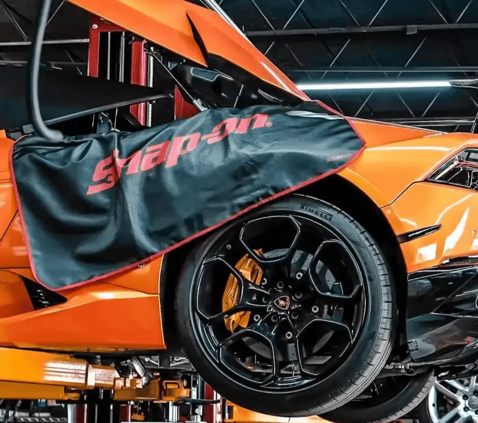 a man working on a car in a garage