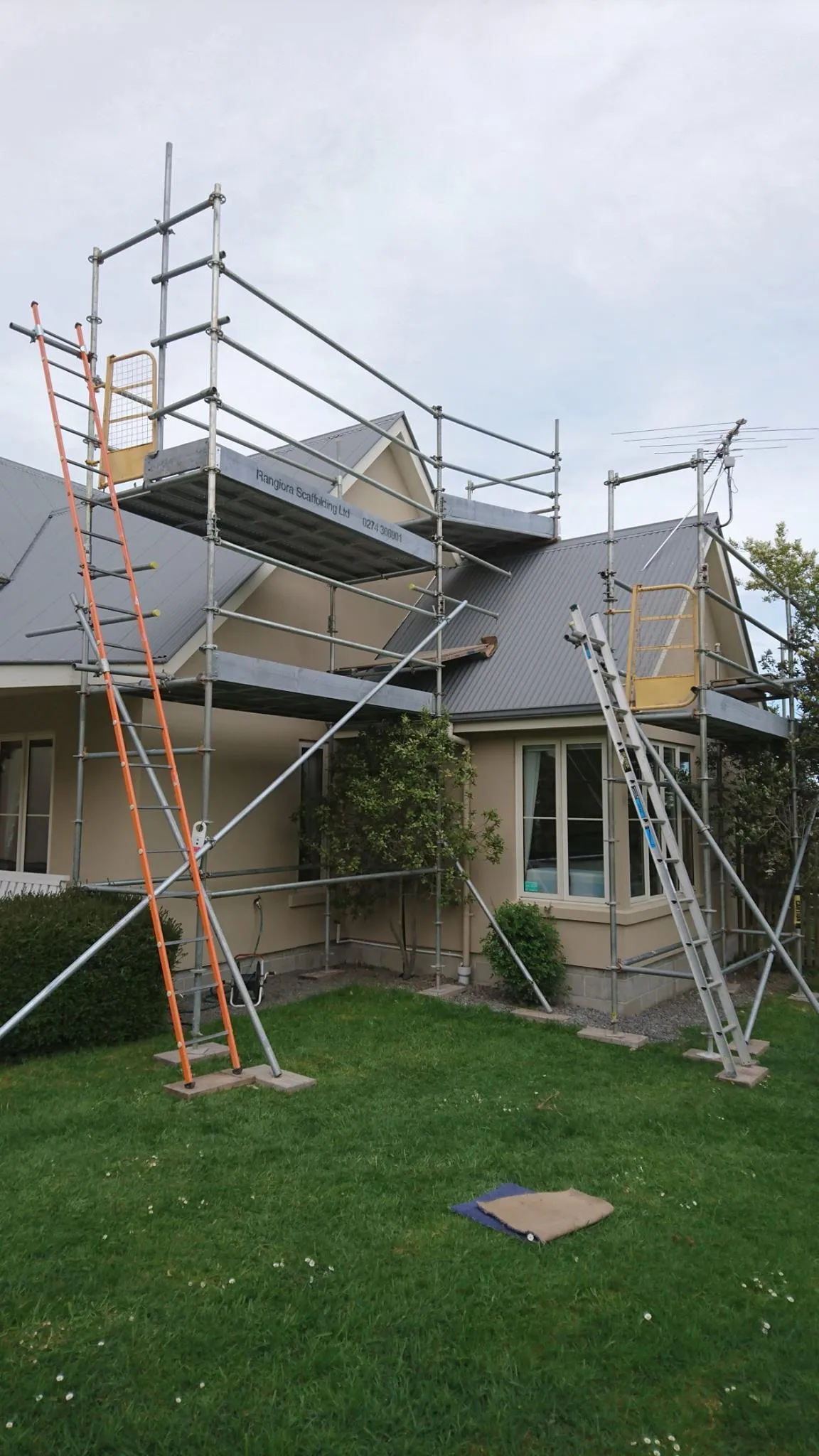 Two-tier scaffold setup installed on a family home in North Canterbury, with full safety access and ladders in place