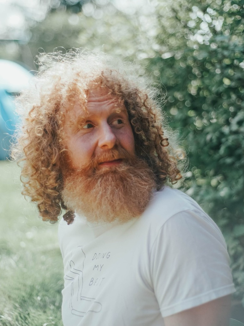 Woman learning guitar from laptop at home