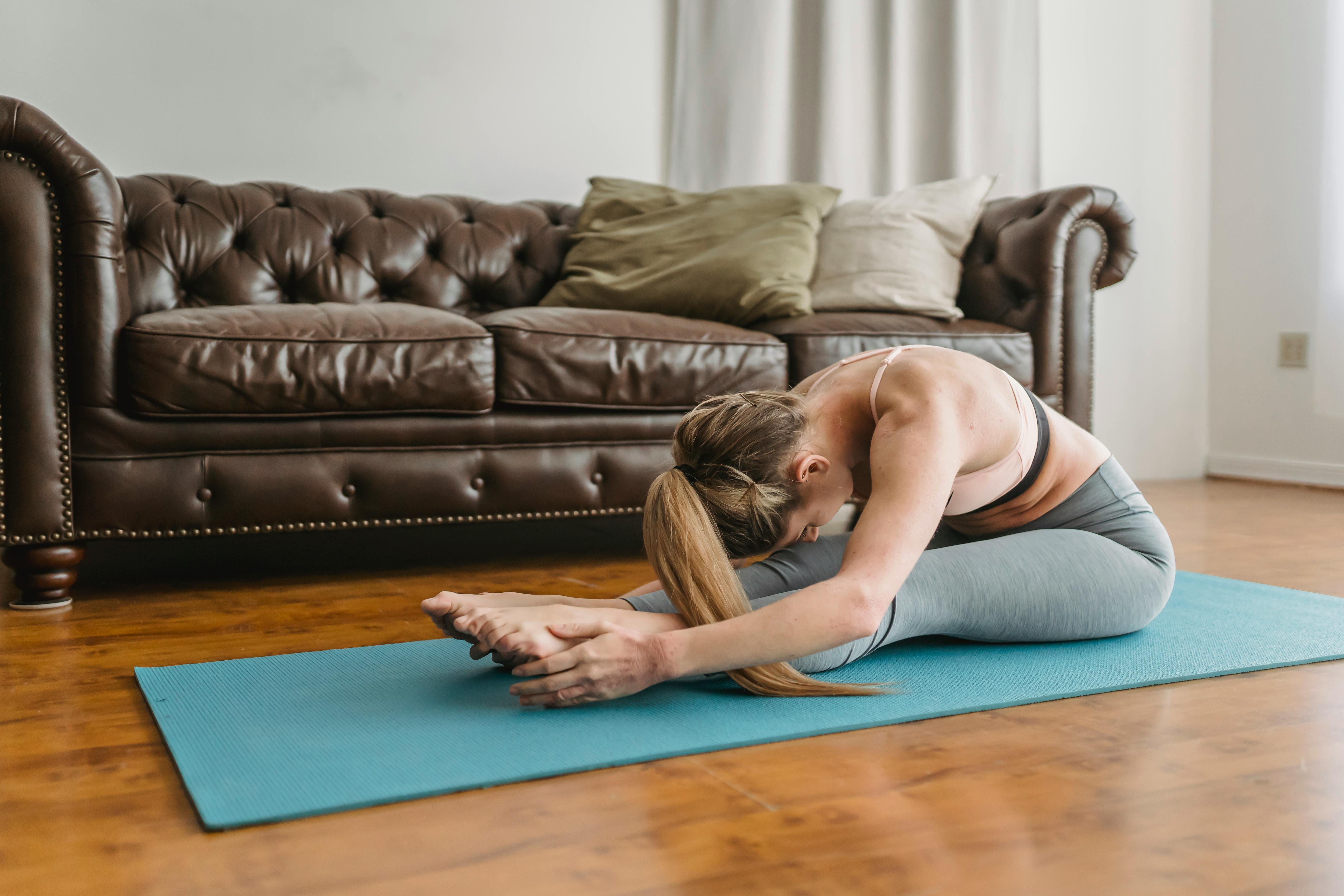 Dancer stretching on studio floor following guided recovery routine
