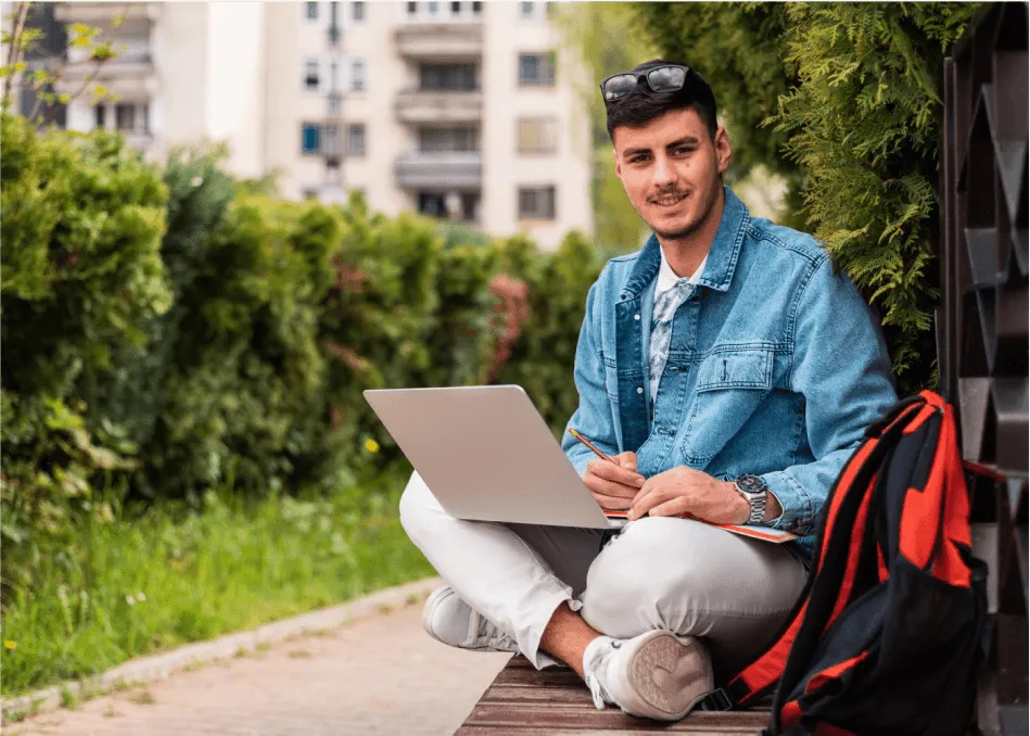 Man working on laptop outdoors representing passive income success