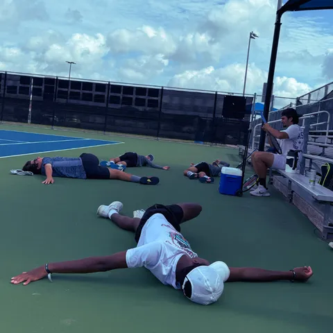High-performance tennis players recovering after intense physical training – Zenniq Academy recovery and stretching program for junior athletes in Katy, Texas