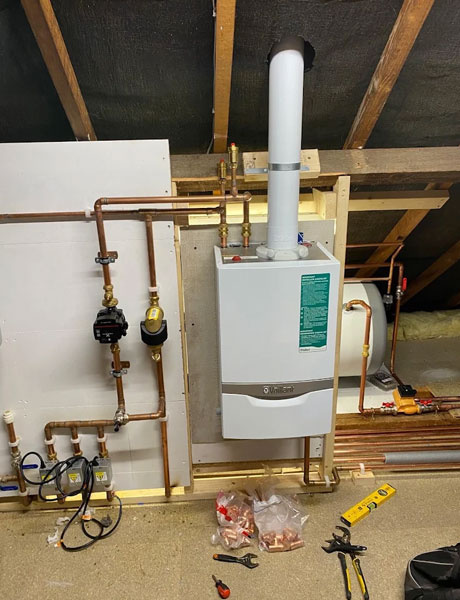 Plumber in a kitchen with a customer