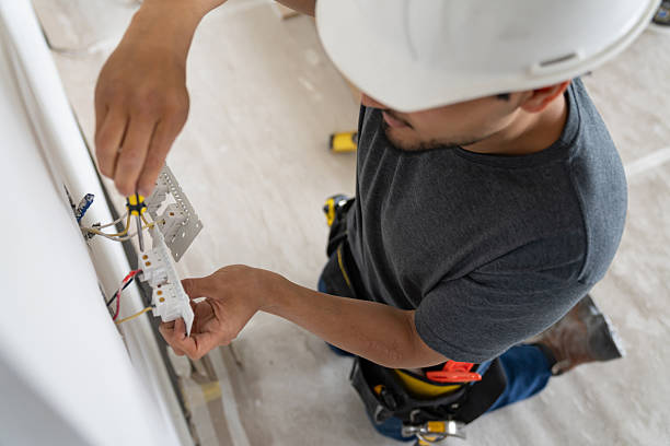 Electrician wiring a wall socket